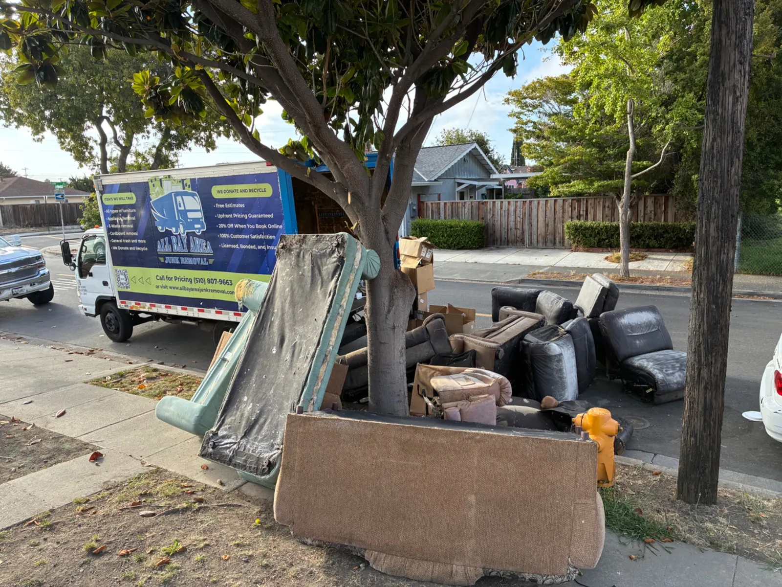 Curbside junk pickup next to the All Bay Area Junk Removal truck