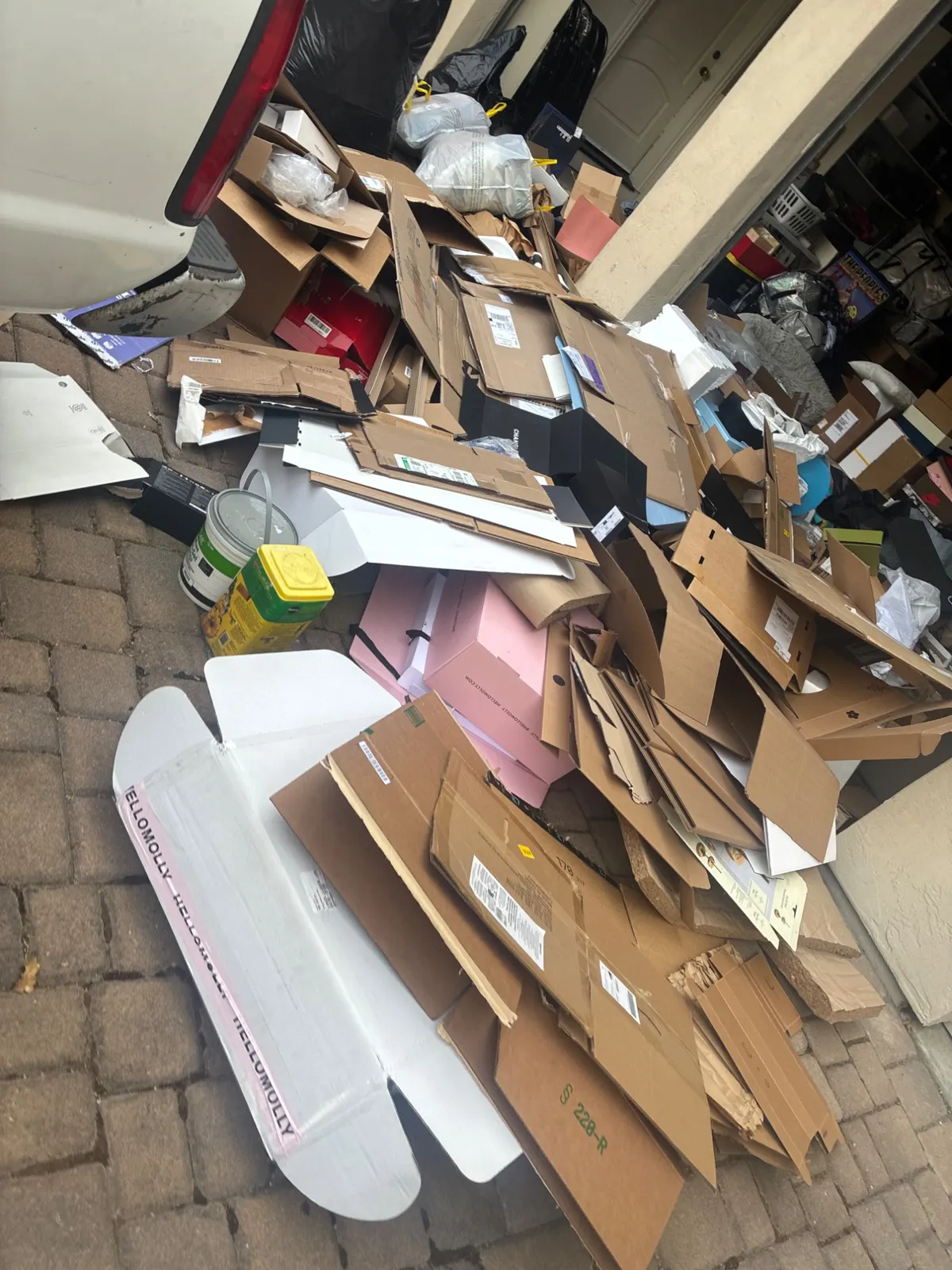 Cardboard and debris pile before removal