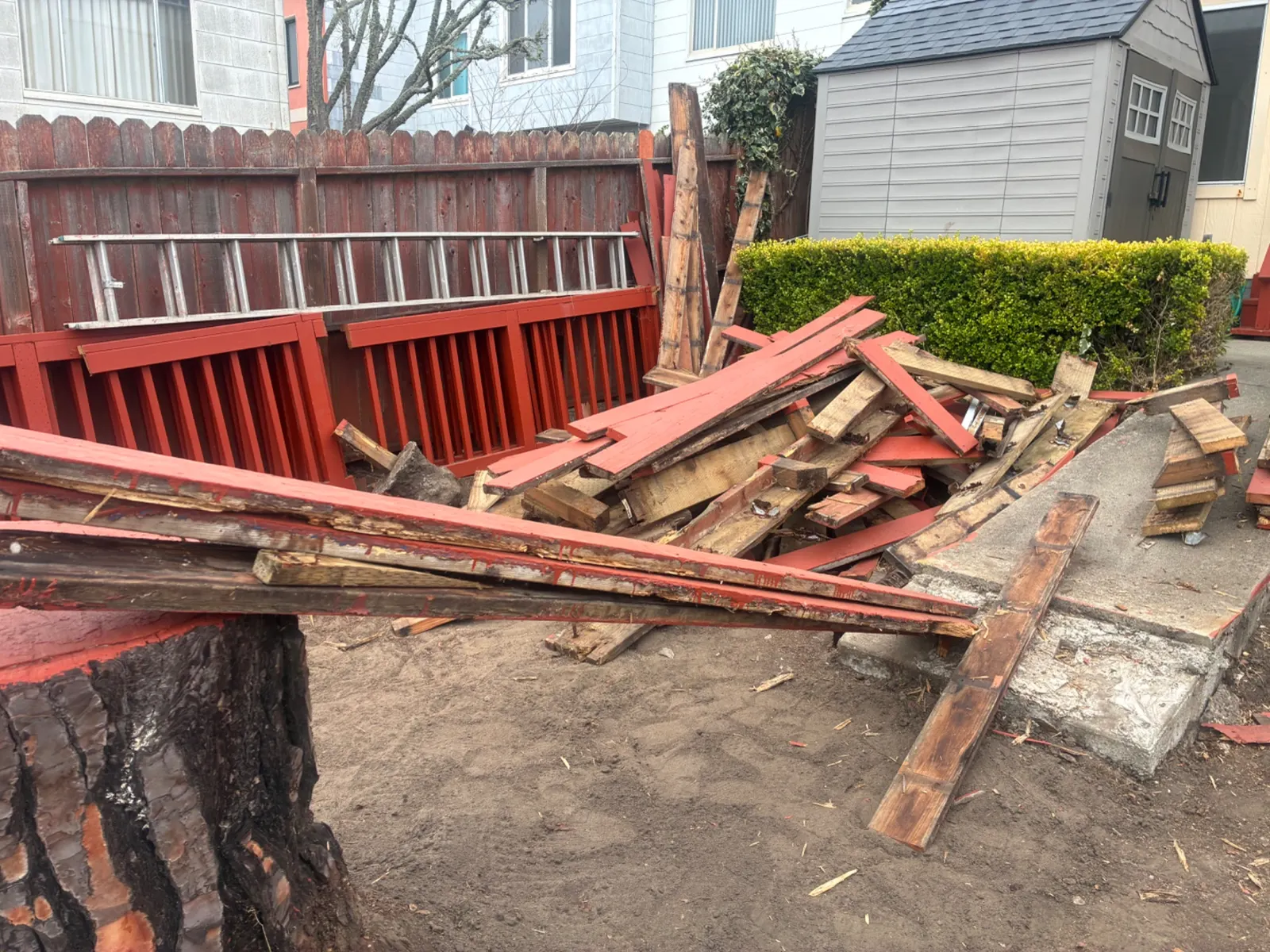 Backyard deck demolition debris before cleanup