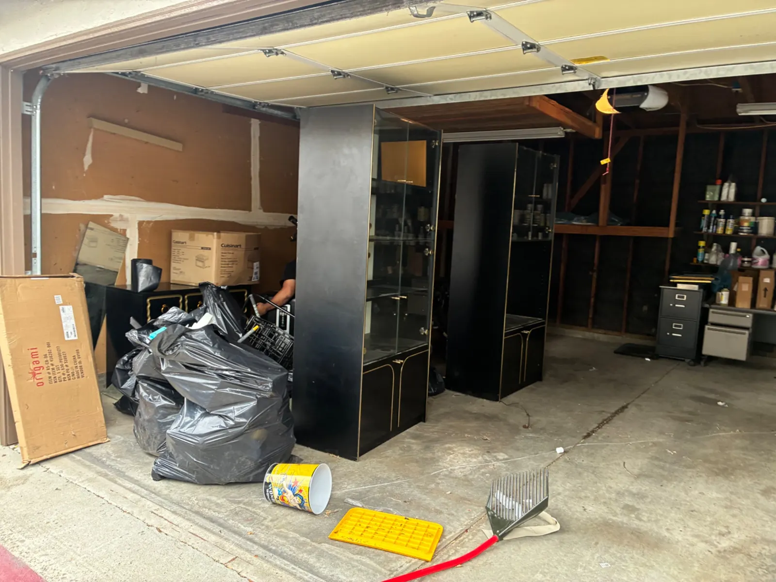 Garage full of junk and bags before a cleanout