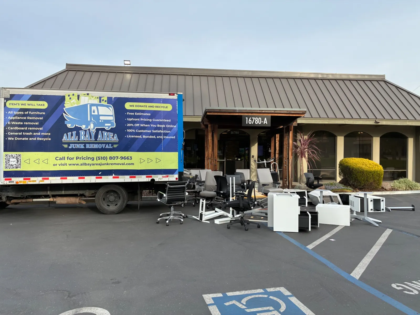 Office chairs and furniture staged beside the All Bay Area Junk Removal truck