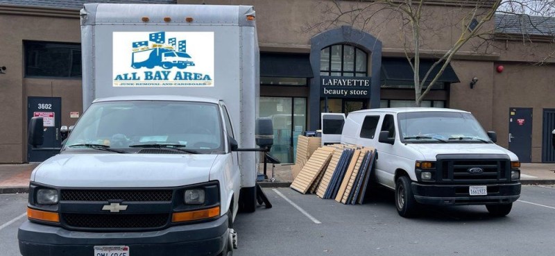 A red banner with "Junk removal" text overlays an image of two white vans from All Bay Area Junk Removal and Hauling.